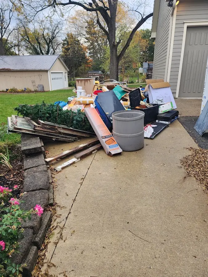 Dumpster being loaded with debris for Estate Cleanout Dumpster Rental in Citrus Heights